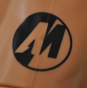 "AM" Action Man logo on his left arm